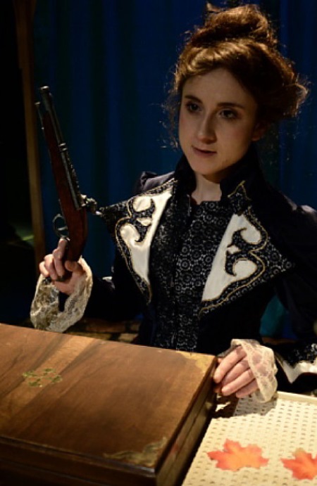 Picture of Helen Bonifacio as Hedda Gabler holding the General's pistol